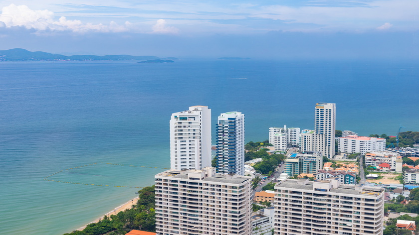 sea-by-modern-buildings-against-blue-sky